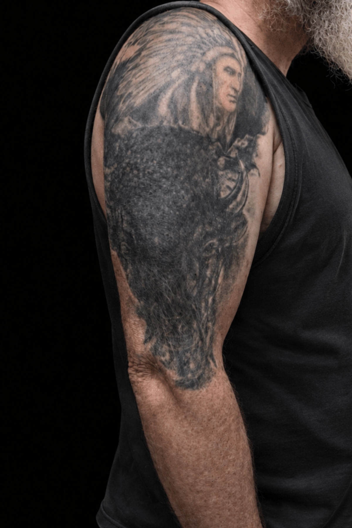 Old faded Viking tattoo before cover-up transformation in Berlin